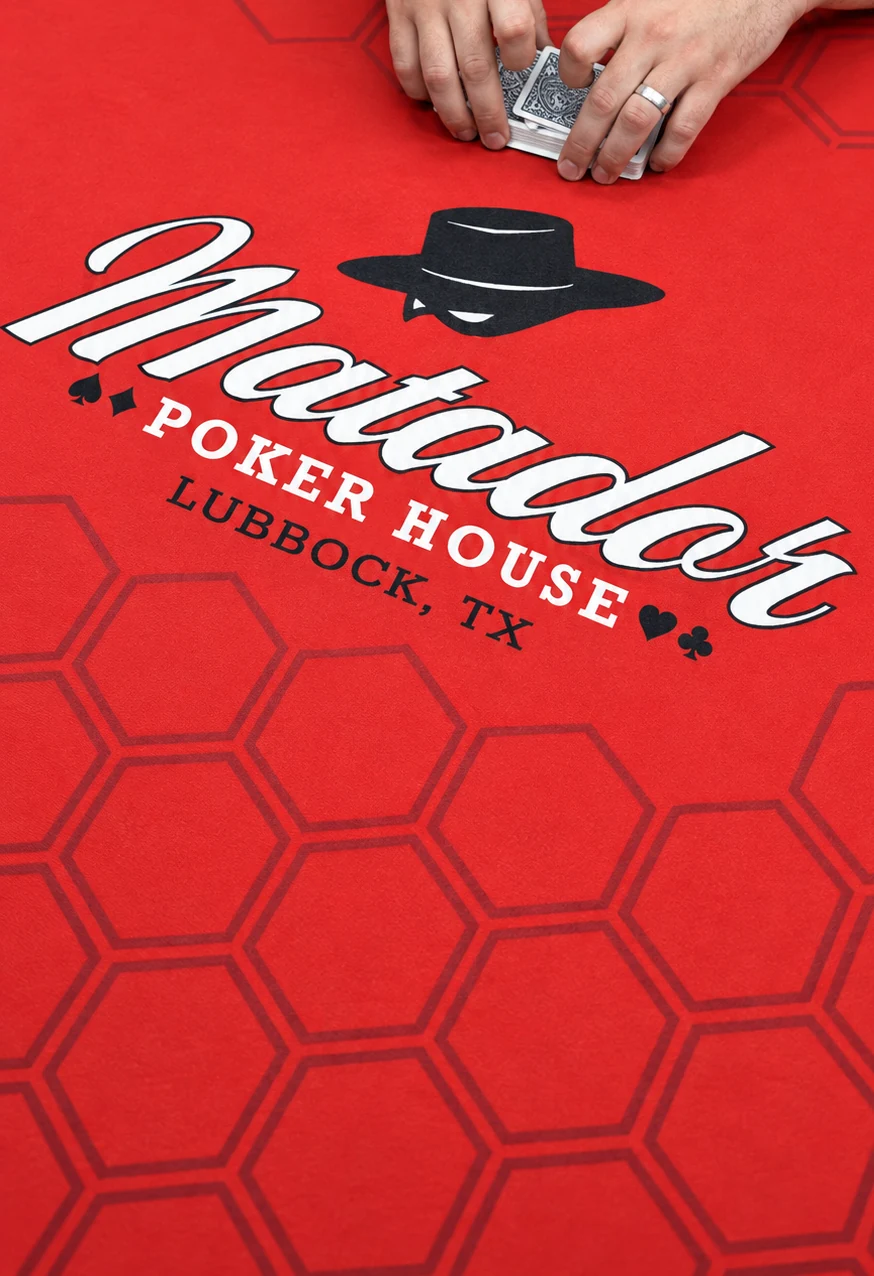 Matador lettering and hat graphic on the red table felt.